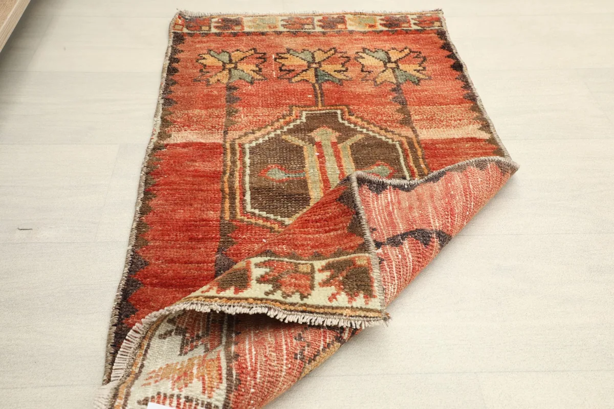 Another view of the rug partially folded, displaying its overall design and texture