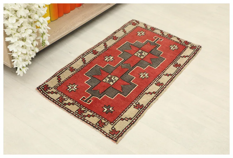 Full top view of the 1'10" x 3'0" red geometric Anatolian rug on a white background.