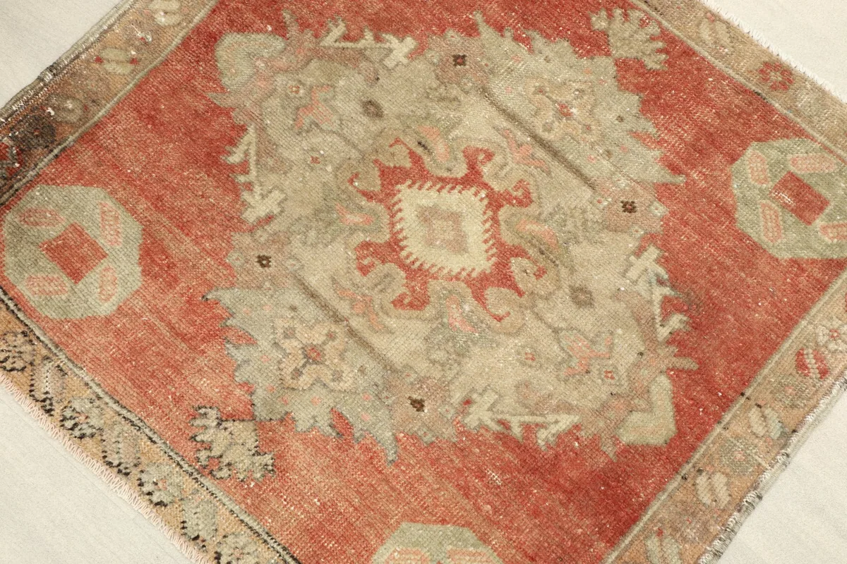 Angled view highlighting the texture and color variations of the hand-knotted vintage wool rug.