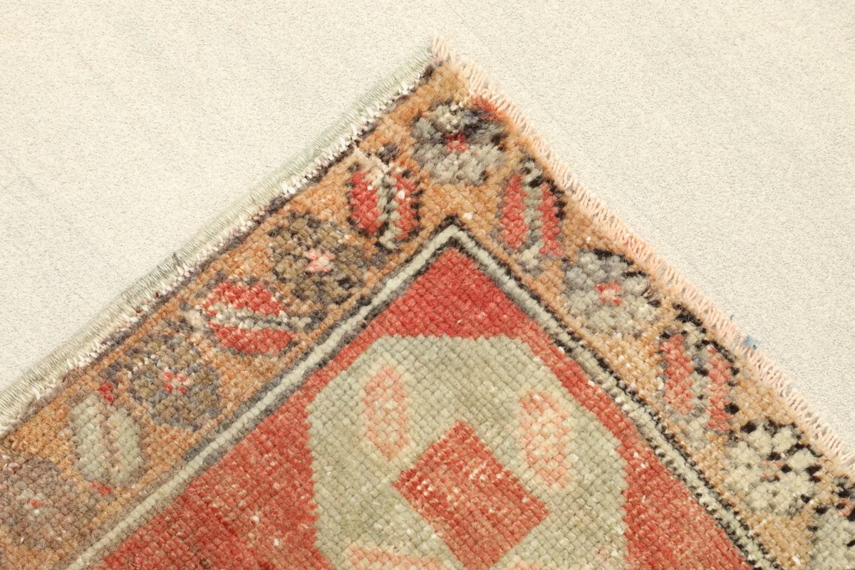 Corner detail showing the intricate border design and fringe of the vintage Anatolian rug.