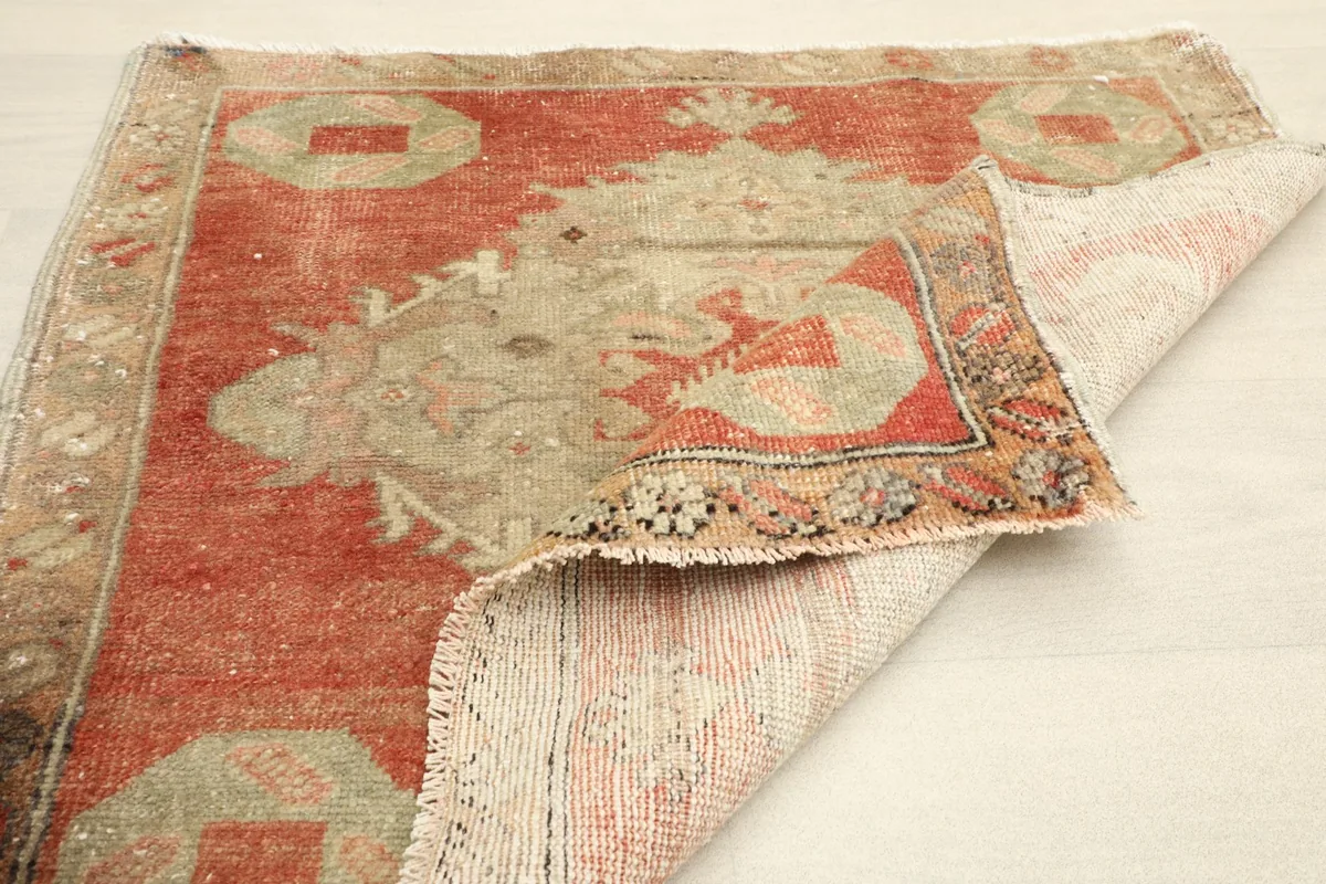 The rug partially folded, illustrating its flexibility and the quality of the wool pile.