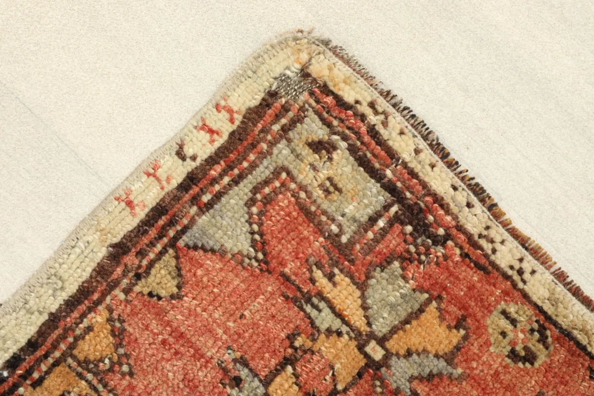 Corner detail showing the hand-knotted construction and subtle border design