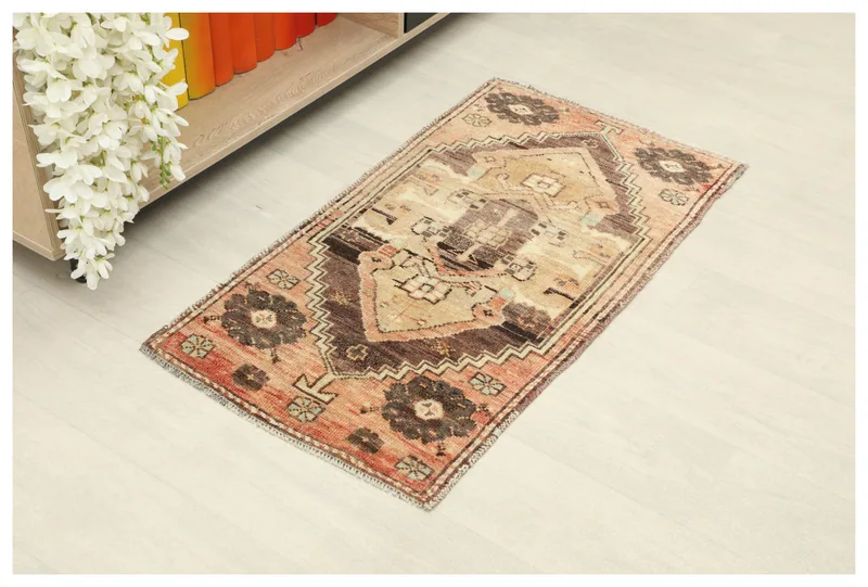 Full top view of the 1'9" x 3'3" vintage orange and brown Anatolian doormat rug on a white background
