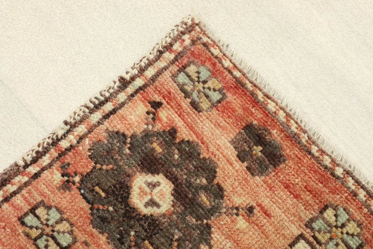 Corner detail showing the edge finishing and the subtle color variations in the orange and brown hues