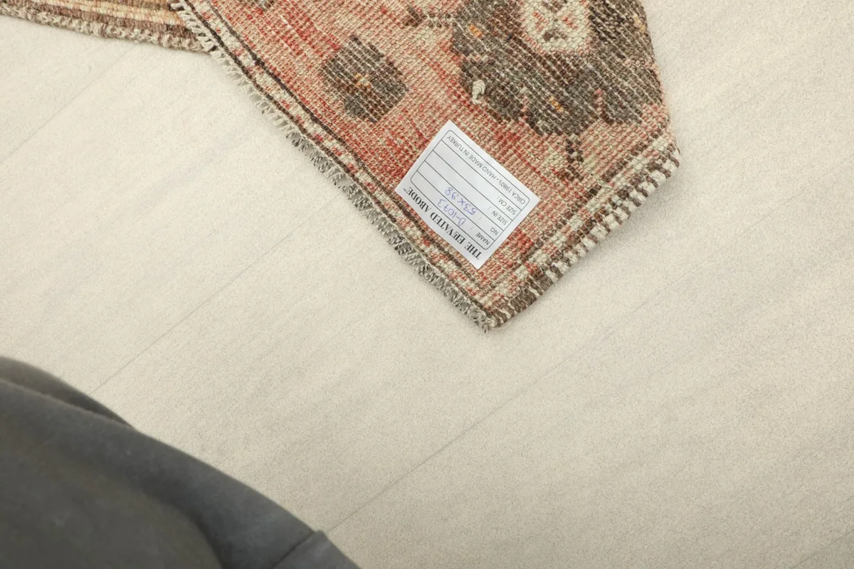 Close-up of the back of the rug, showing the knotting structure and product label