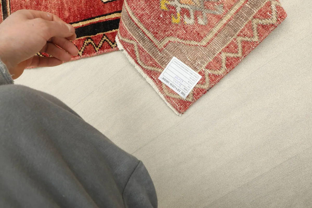 Close-up of the rug's back, showing the hand-knotted cotton foundation and wool pile