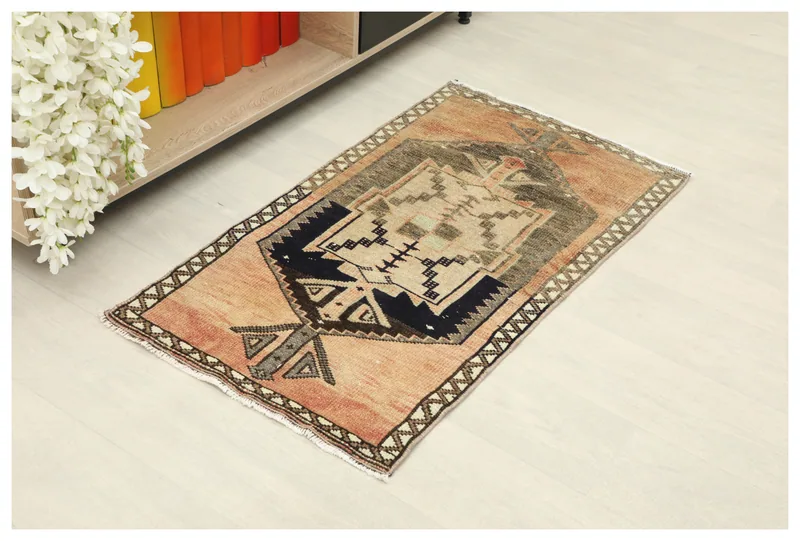 Full top view of the 2x3 rose and navy geometric vintage Anatolian rug on a white background.