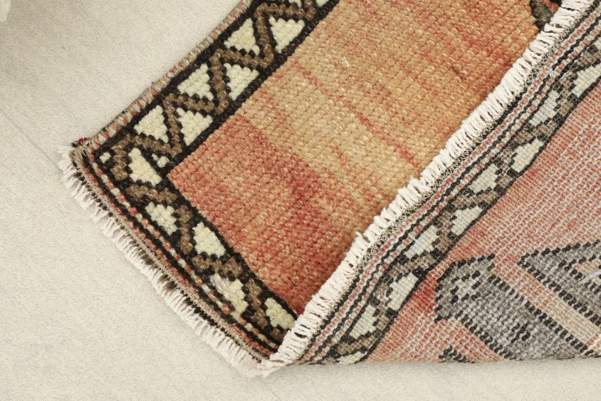 View of the low wool pile and the hand-knotted texture of the vintage Anatolian rug.