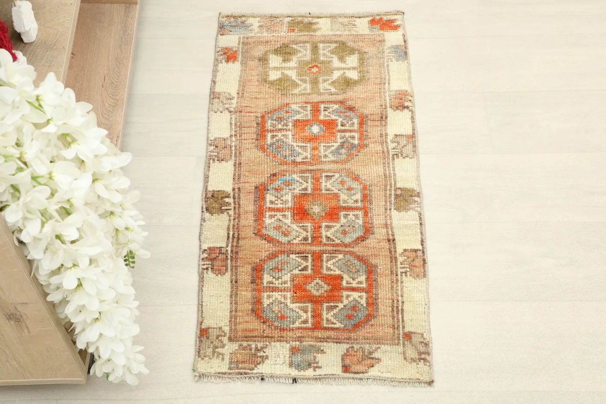 Direct overhead shot of the hand-knotted wool doormat, highlighting its tribal geometric motifs.