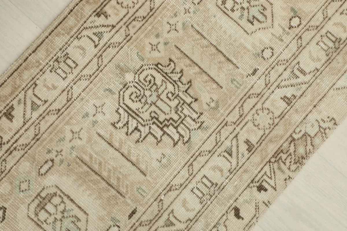 Overhead view showing the central geometric and tribal pattern of the vintage Anatolian rug.