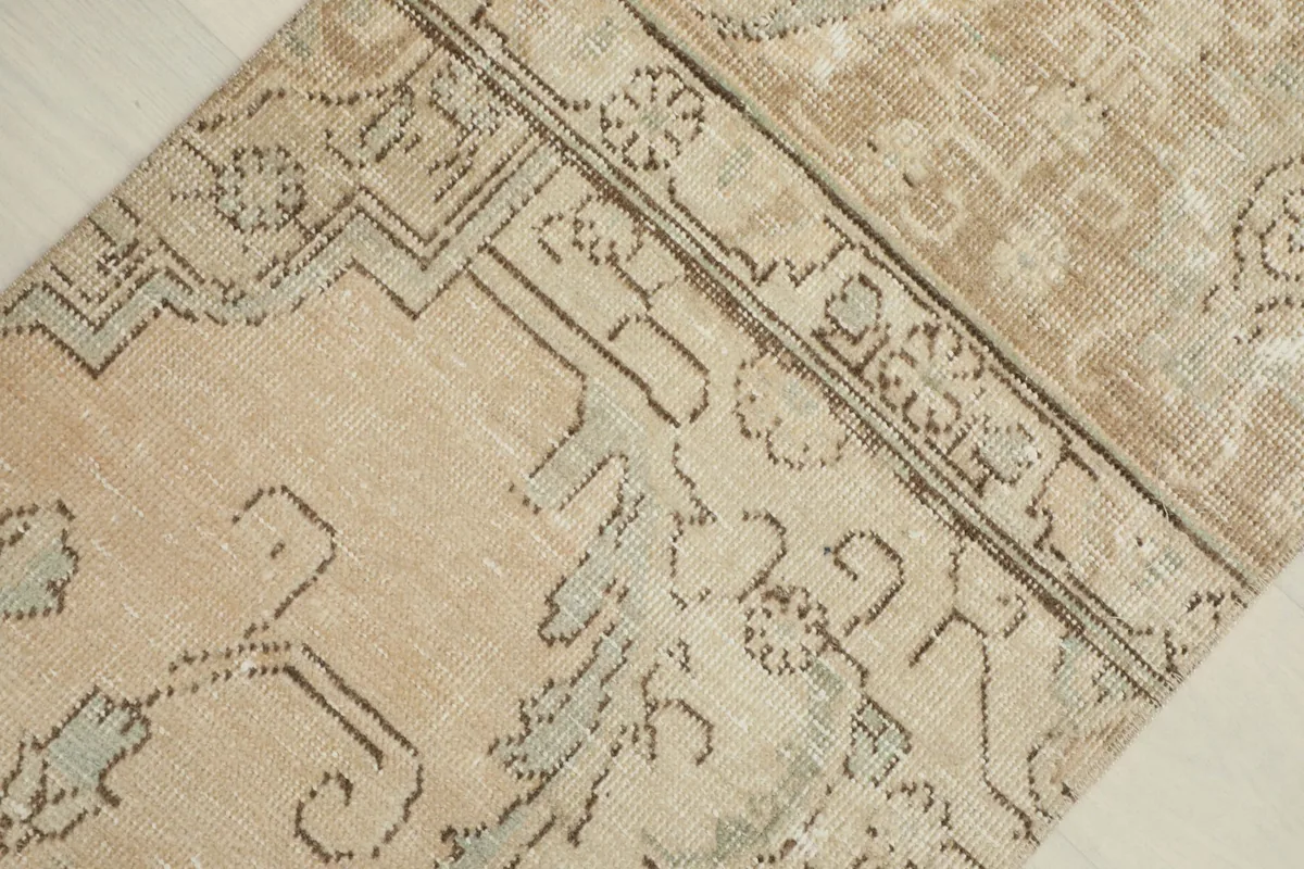 Detailed view of the rug's central floral and geometric patterns with subtle color variations