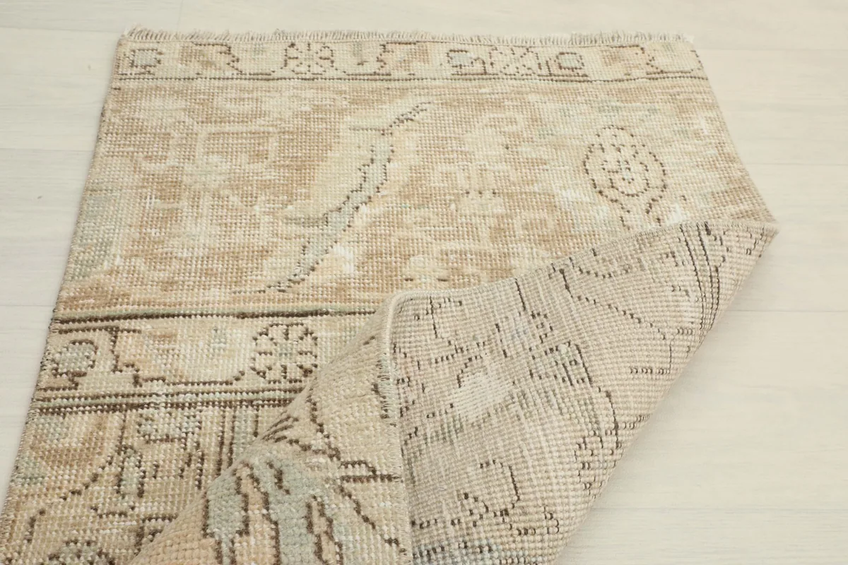 Partial view of the rug's back, showing the hand-knotted construction