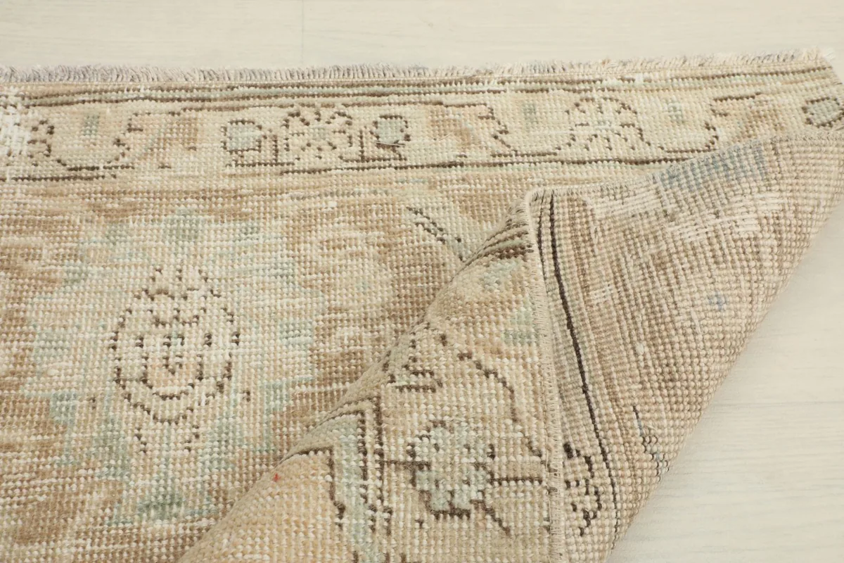 Partial fold of the rug, illustrating the flexibility and thickness of the wool pile