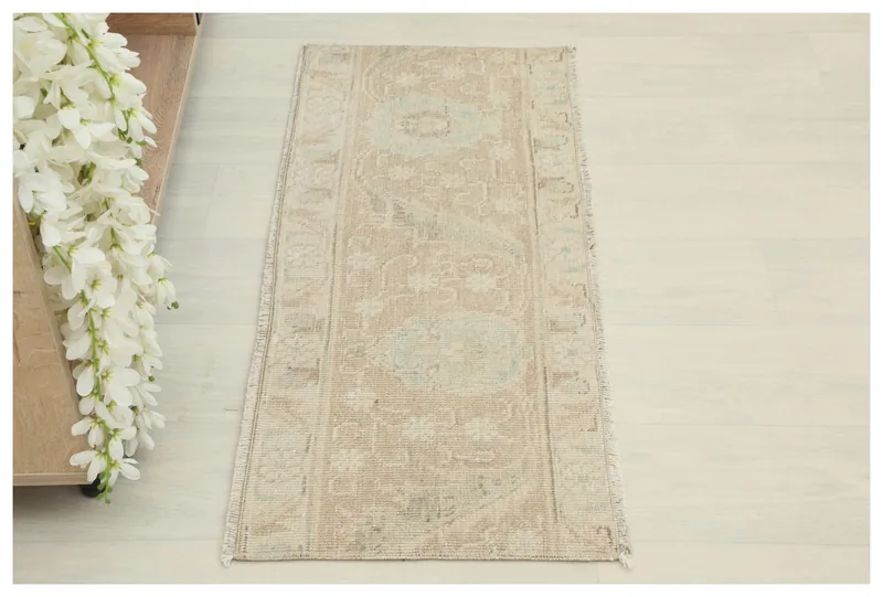Full overhead view of a 1'4" x 3'3" vintage tan and blue geometric runner rug