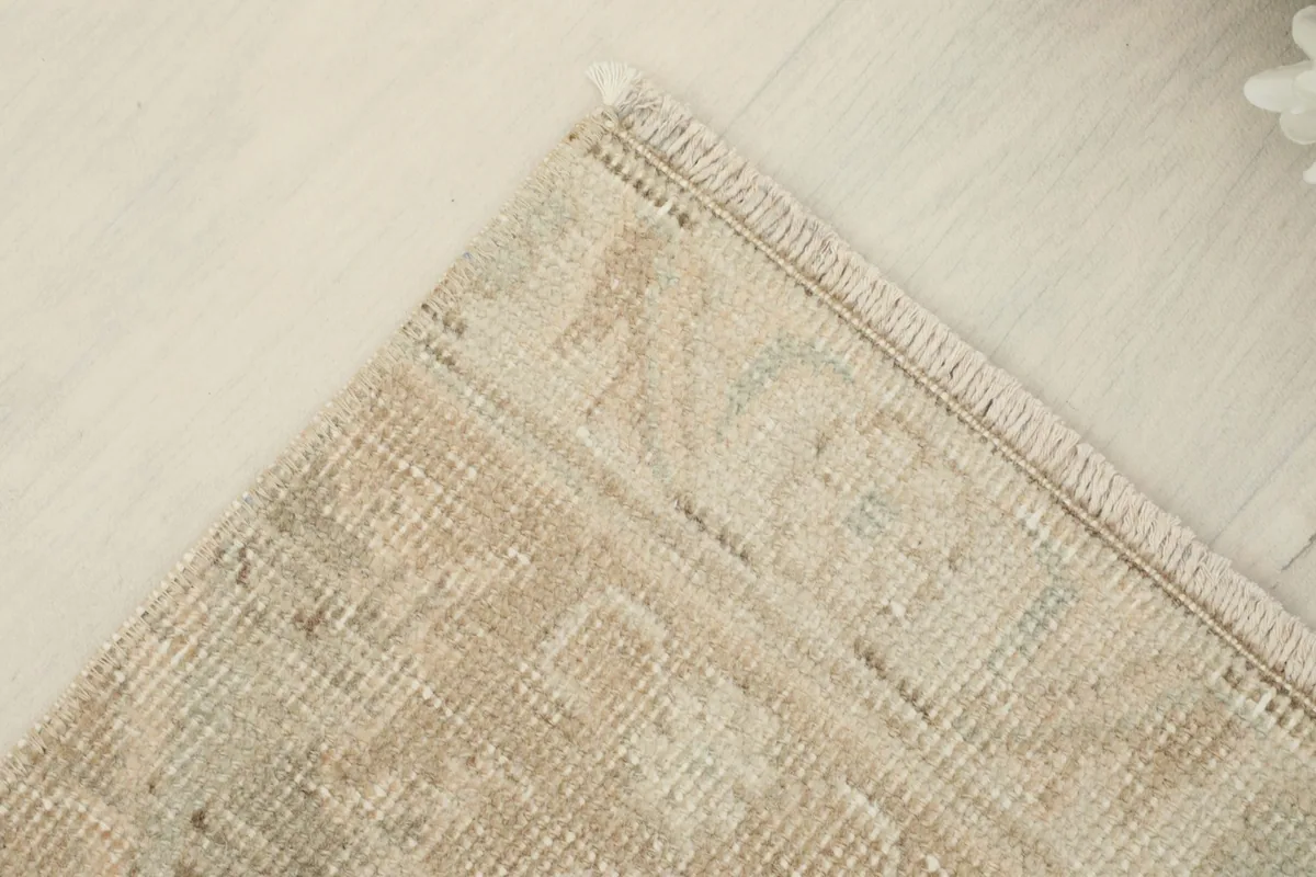 Corner view of the vintage runner rug, showing the integrity of the edges and weave
