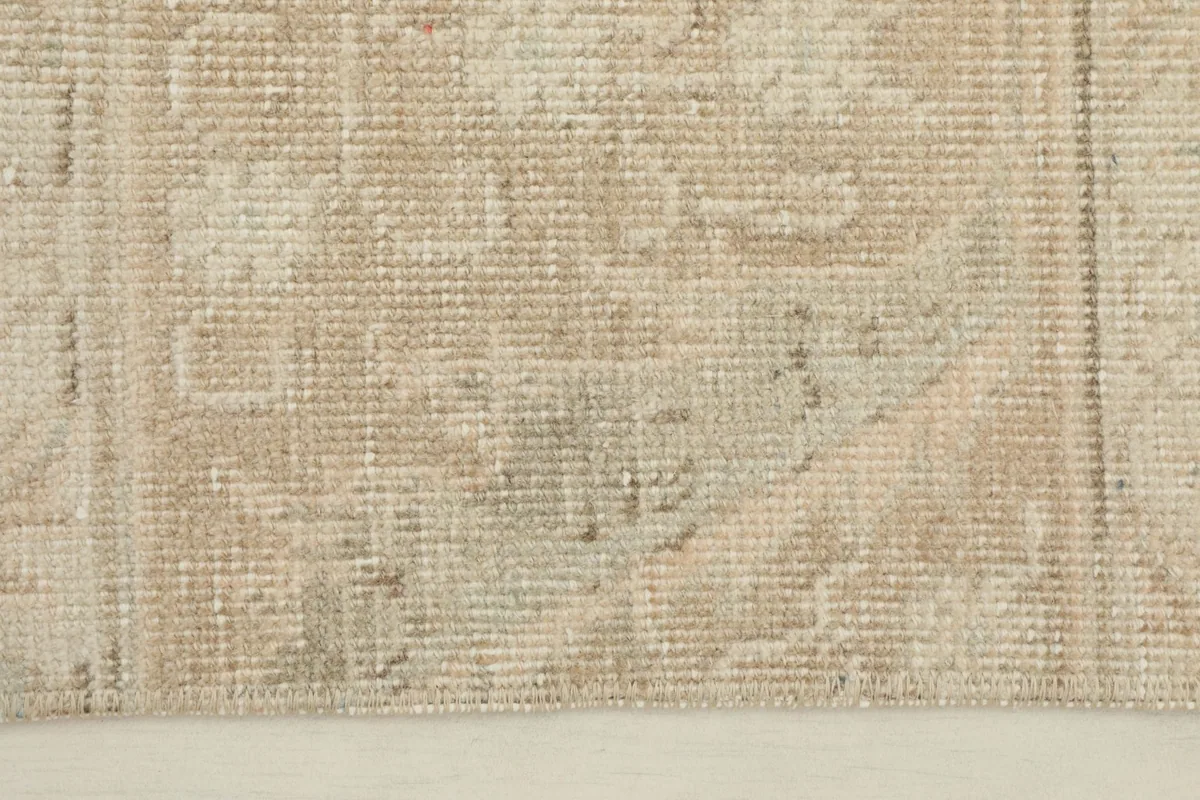 Close-up detail of the hand-knotted wool pile showing geometric patterns and texture