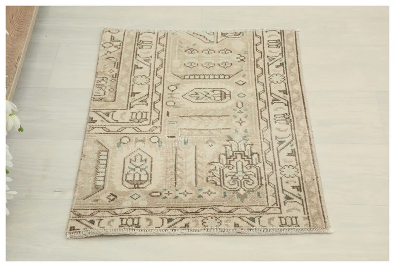 Full top view of the 1'7" x 2'0" beige vintage Anatolian area rug on a white background.