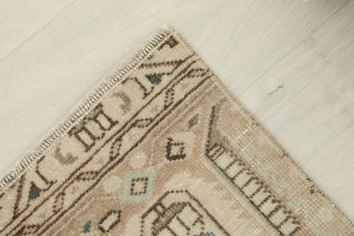 Overhead angled view of one corner, emphasizing the rug's natural patina and slight color fading.