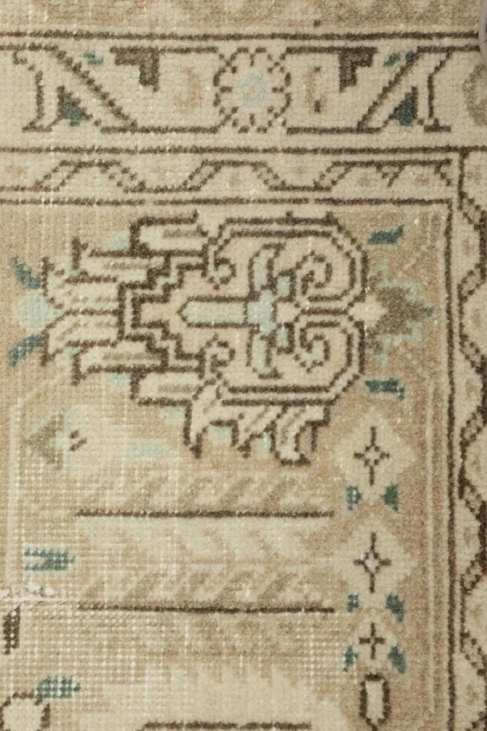 Close-up of a central motif, showcasing the intricate hand-knotted wool pile and design.