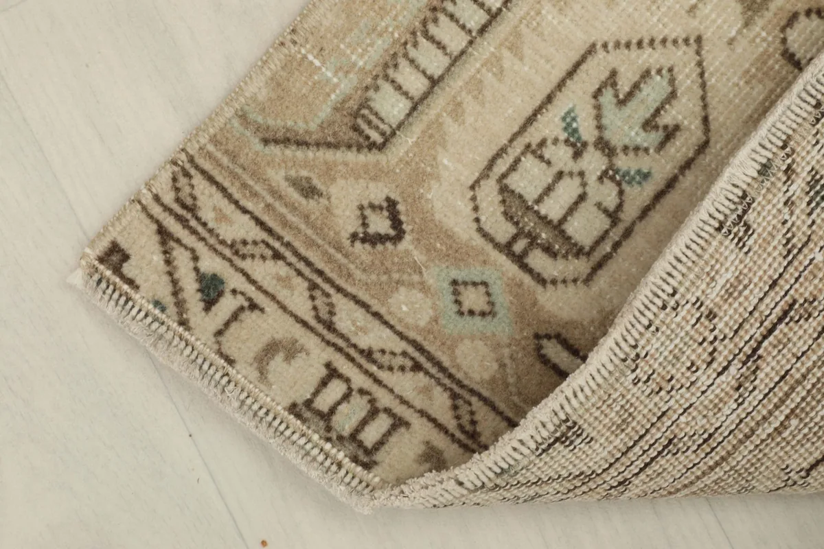 Rug corner folded back to reveal the cotton foundation and construction.