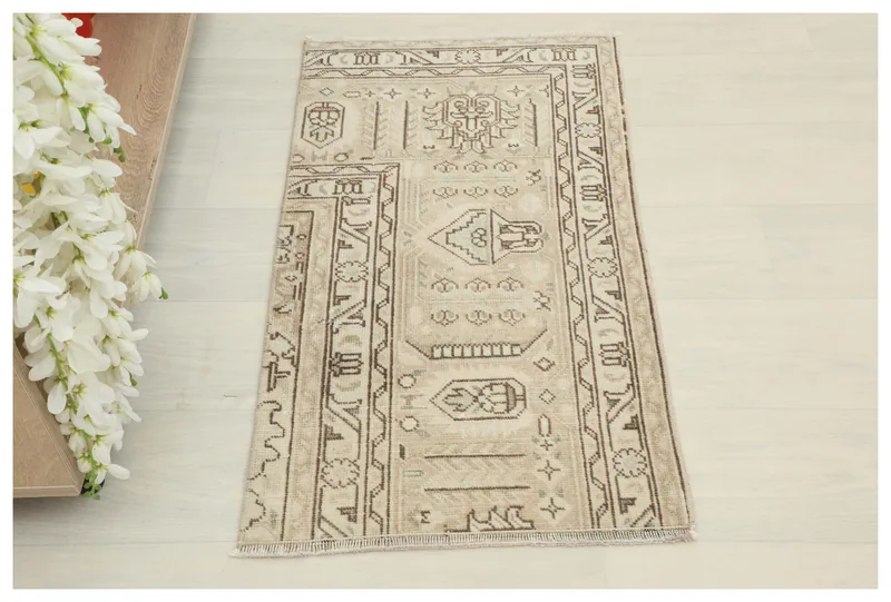 Full top view of the beige and brown vintage Anatolian doormat on a white background.