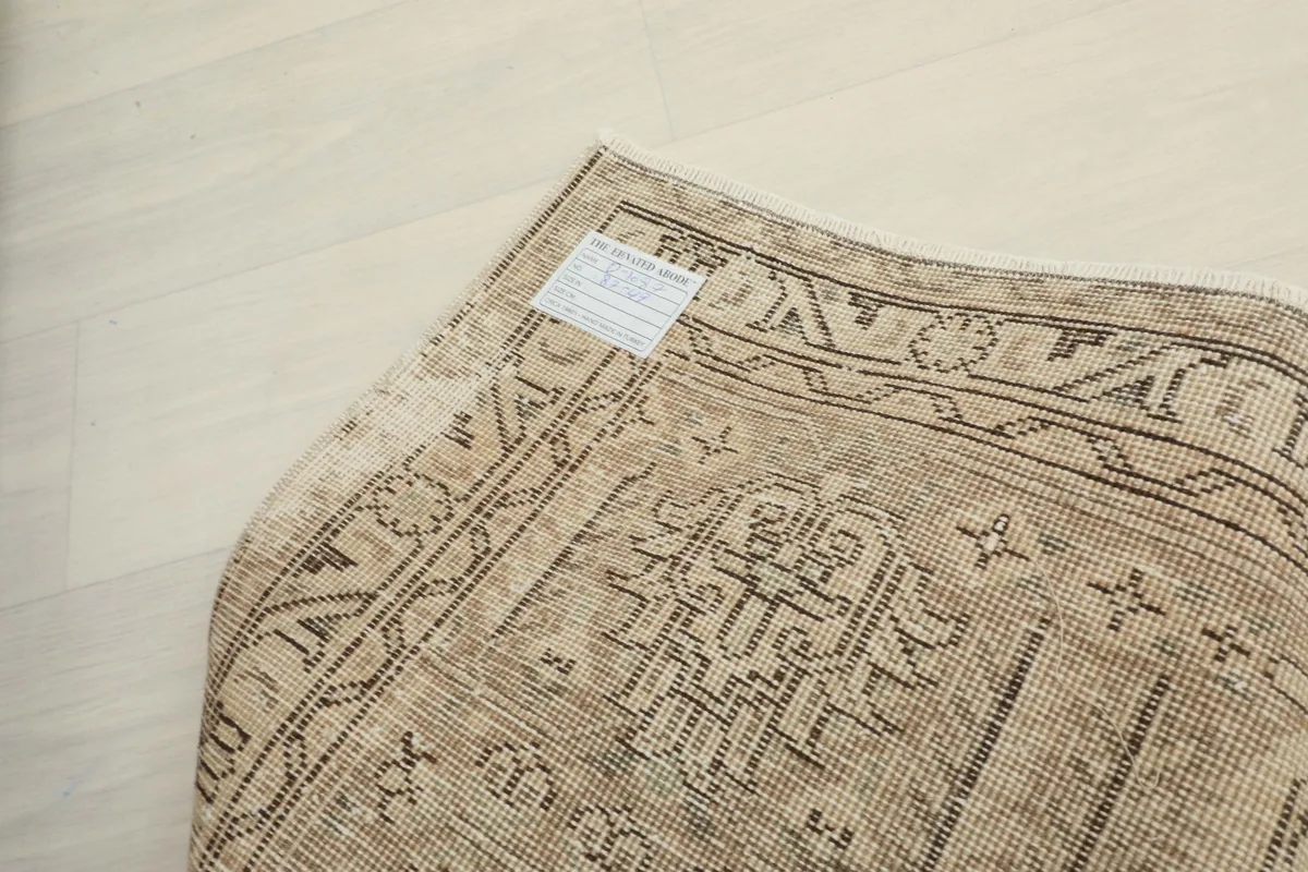 Close-up of the rug's reverse side, displaying the hand-knotted wool pile on a cotton foundation.