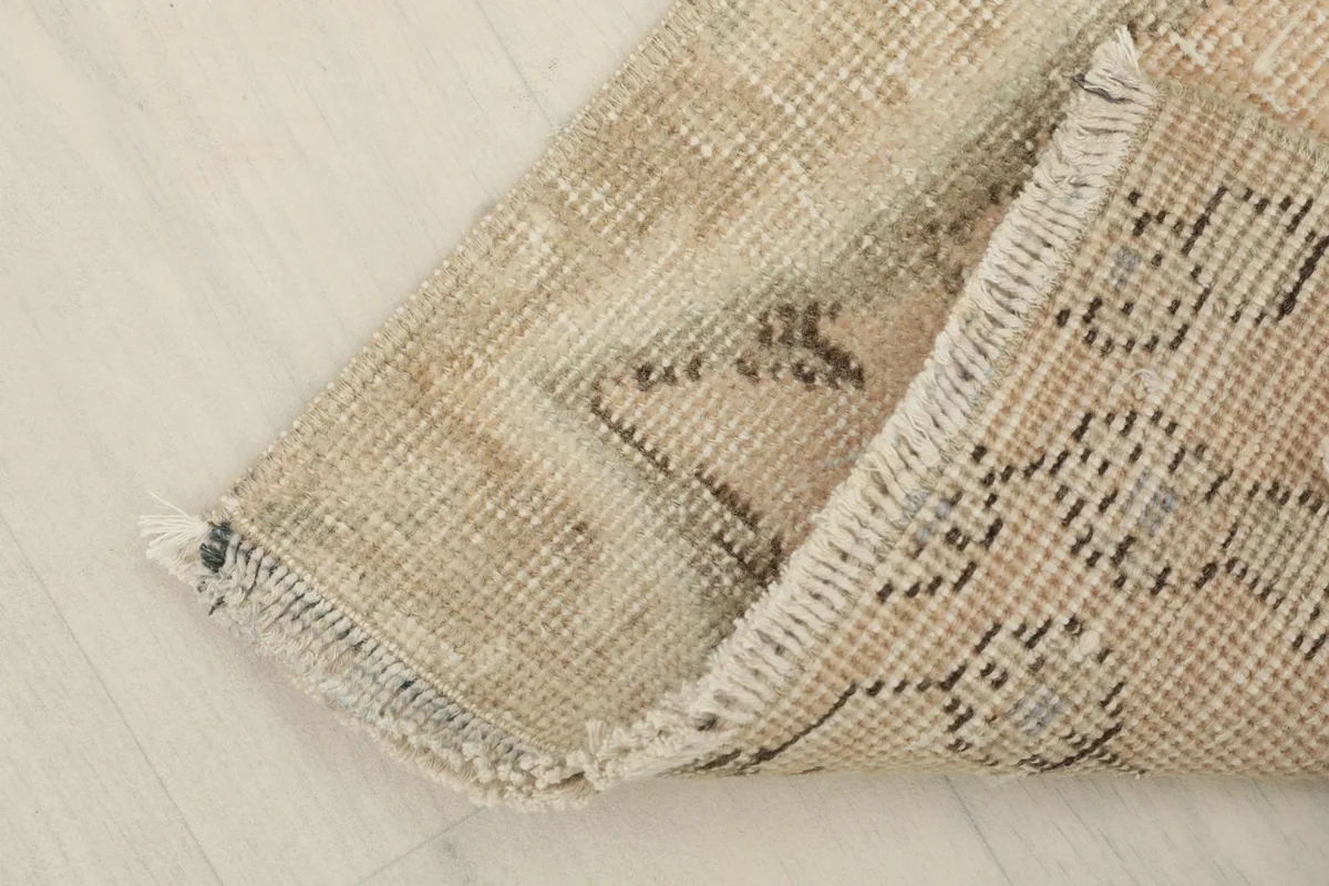 The rug folded to reveal the backside and the tightly woven cotton foundation.