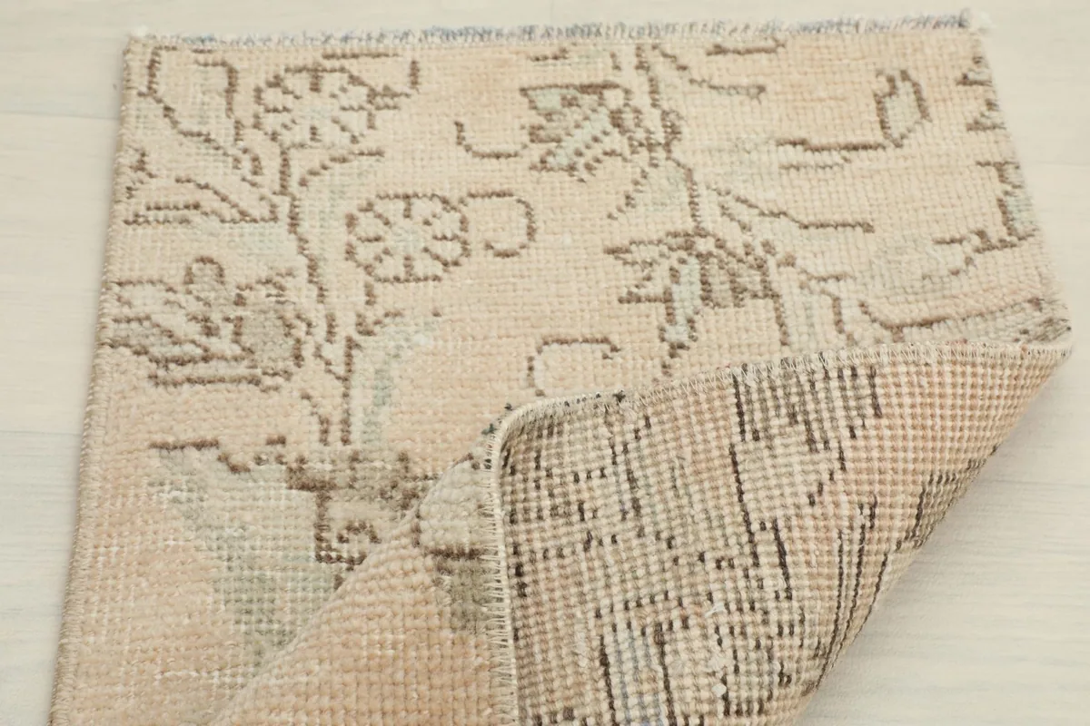 Another view of the rug partially folded, showcasing the hand-knotted construction.