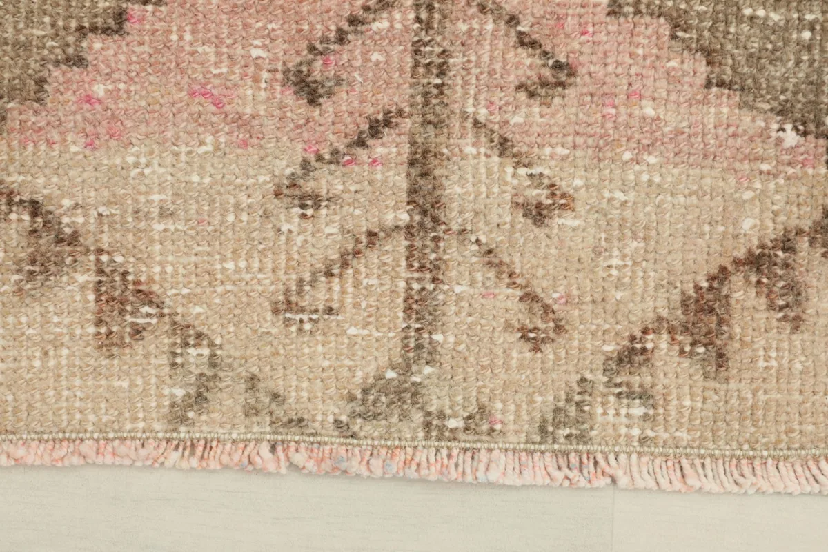 Close-up detail of the rug's lower edge, showing the hand-knotted texture and fringed finish
