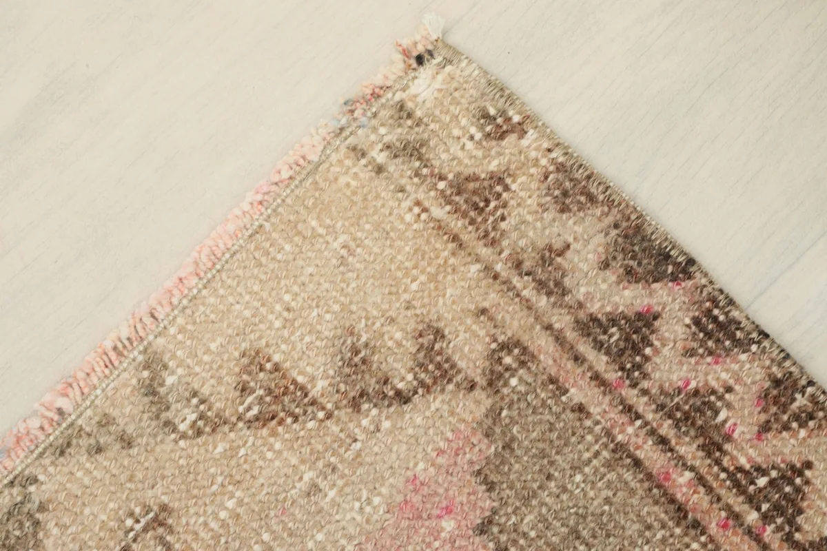 View showing the low pile and texture of the hand-knotted wool, with subtle color fading
