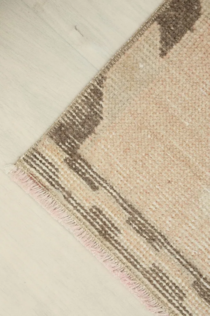 Angled corner view, emphasizing the rug's vintage character and subtle color shifts