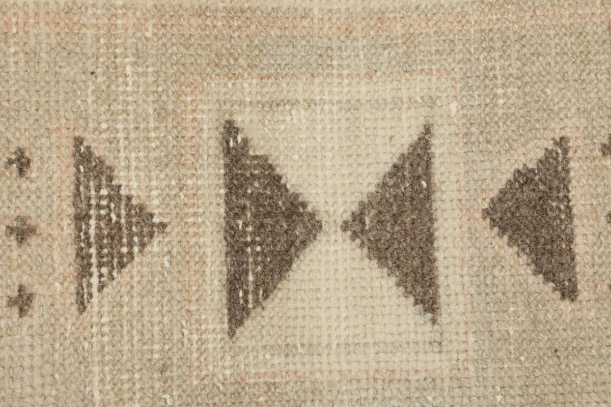 Close-up of the intricate tribal motifs, showcasing the knotting and color variations