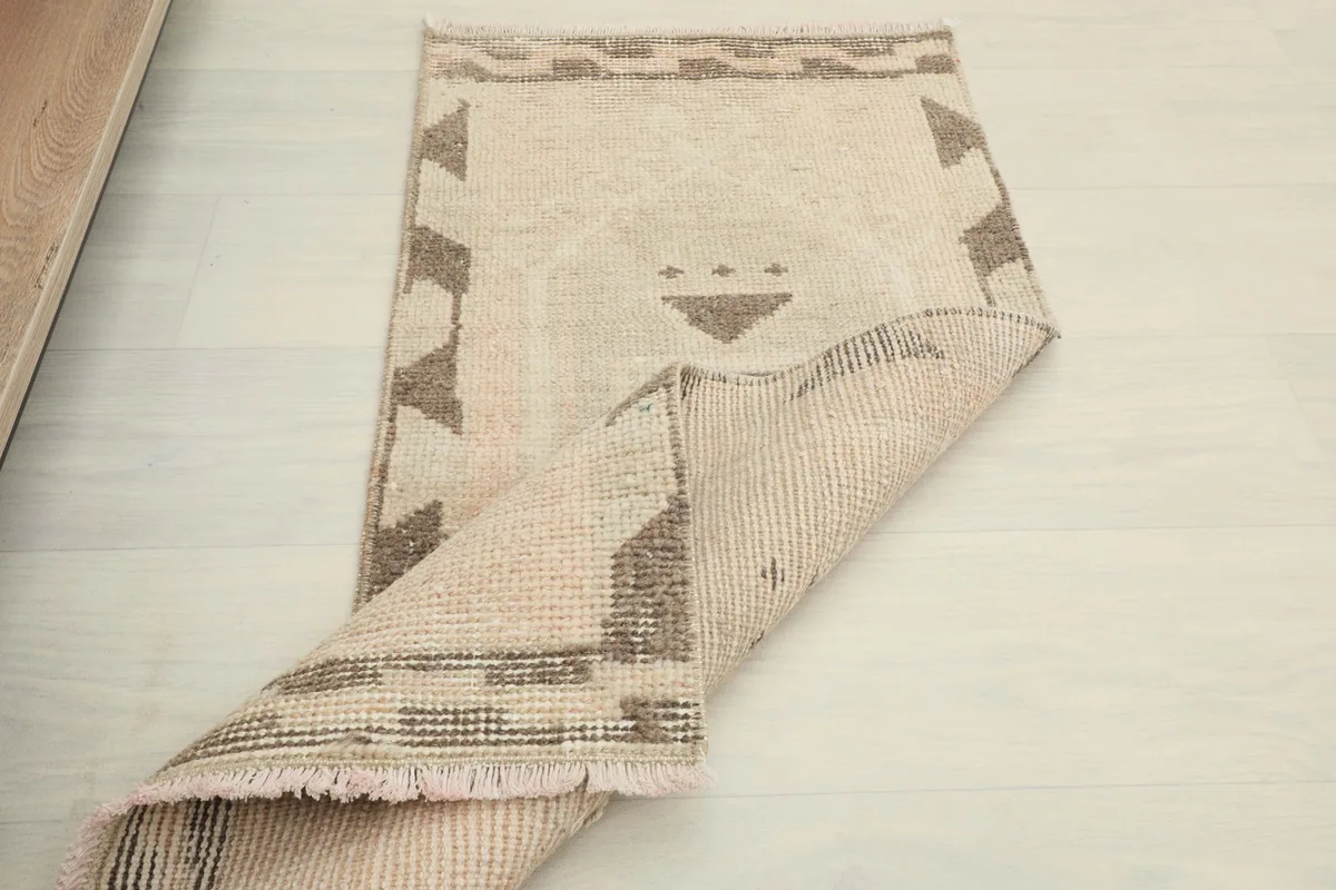 A partial fold of the rug, showing the back of the hand-knotted construction