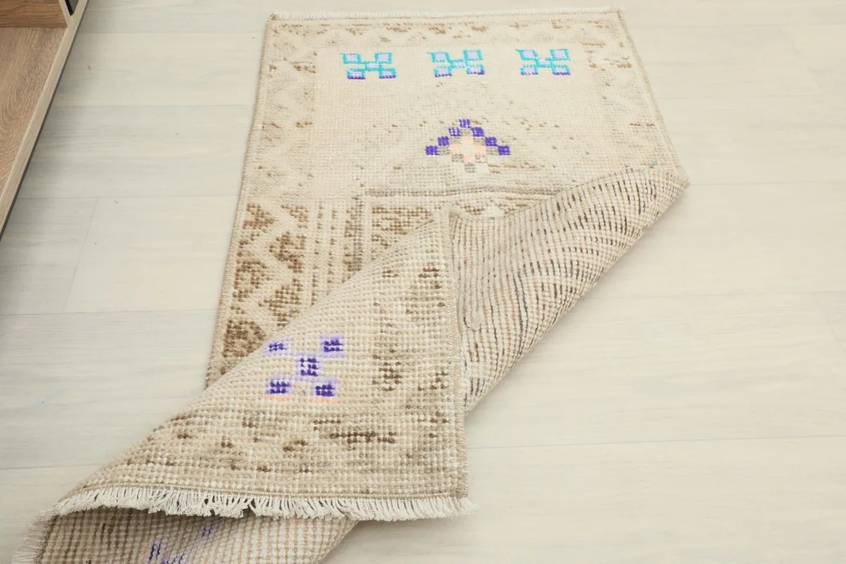 Partial view of the rug's back, revealing the cotton foundation and hand-knotted construction