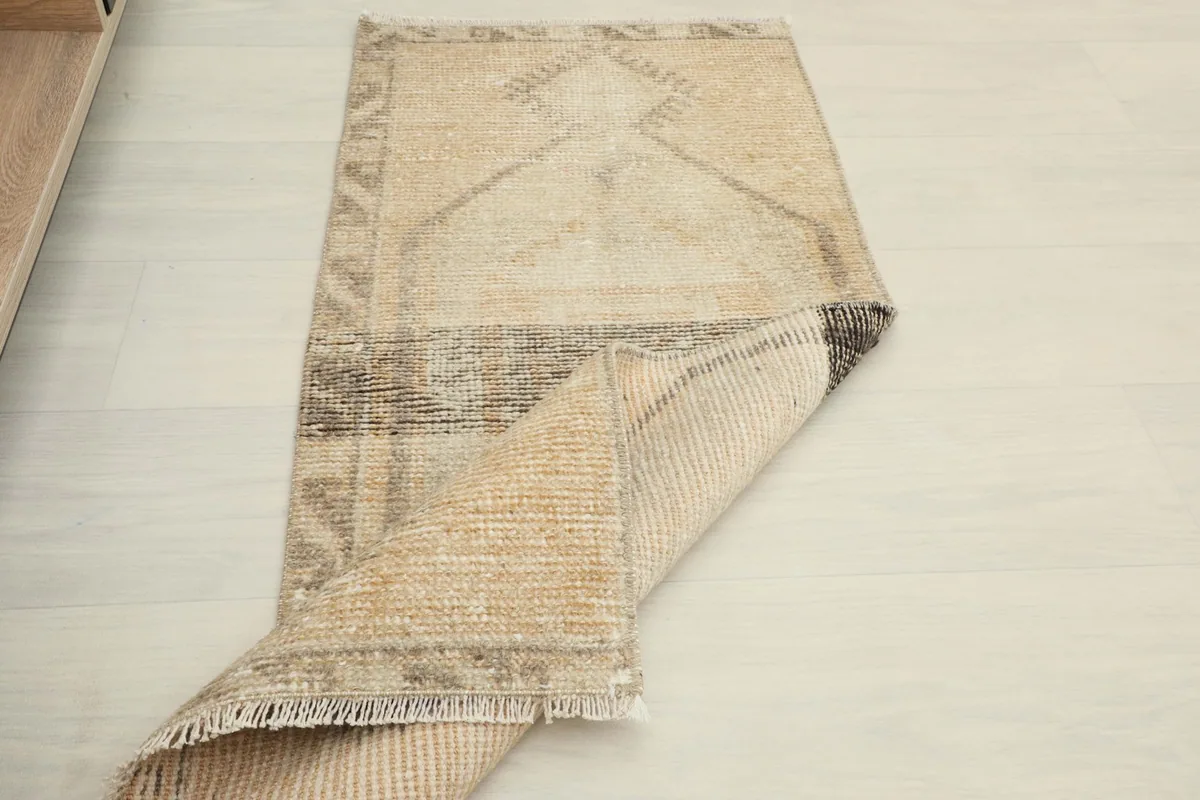 Partially rolled rug, showing the flexibility and the full pattern from an elevated perspective.