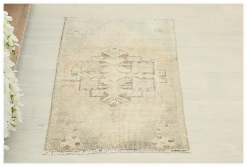 Top view of the 1'8" x 2'7" cream and brown vintage Anatolian area rug