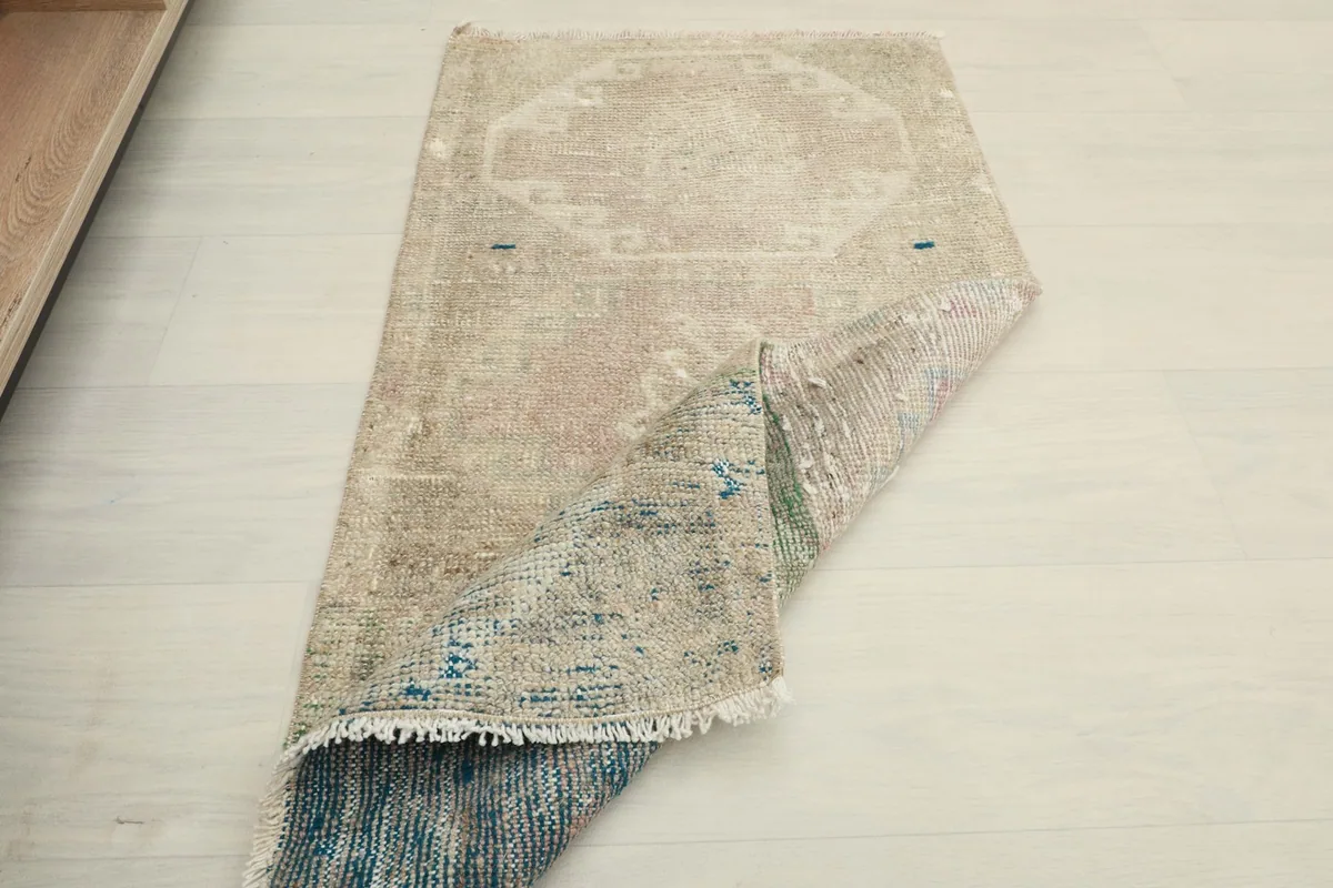The rug folded to show its flexibility and thickness, revealing the reverse side.