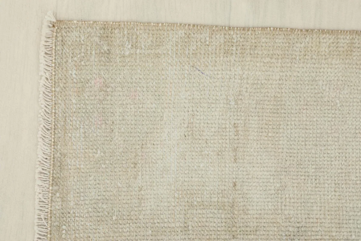 Corner detail showing the finished edge and subtle color shifts in the ivory doormat.