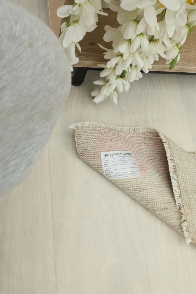 Overhead view of the doormat partially folded, with a white label visible on the back.