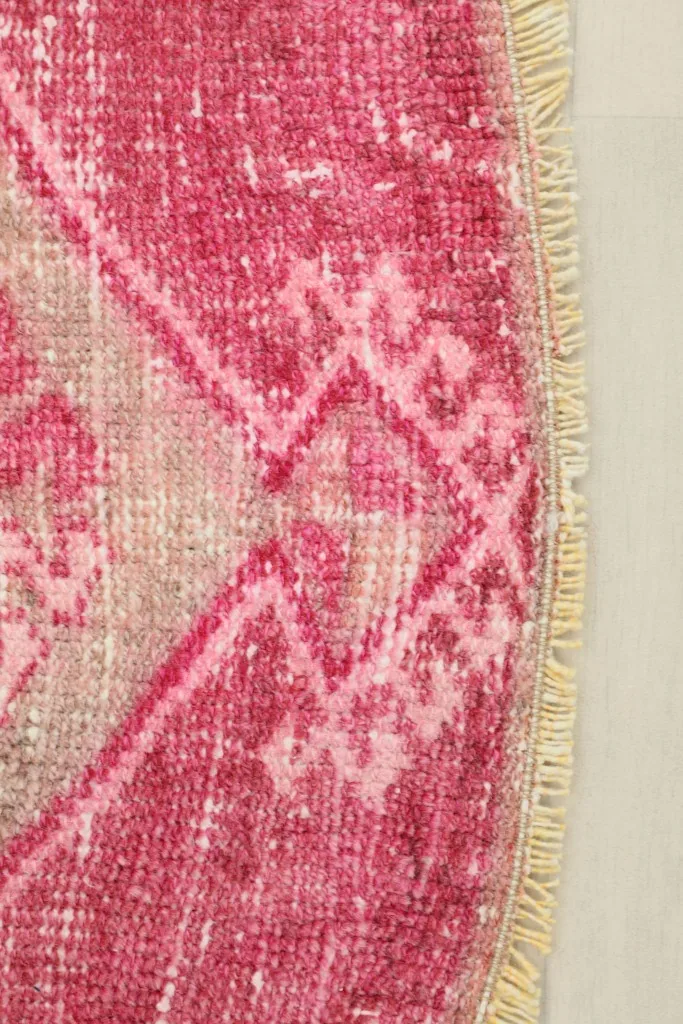 Close-up detail of the rose field with geometric motifs and fringe