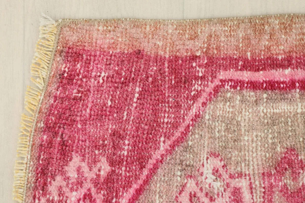 Edge detail of the rug, highlighting the subtle color variations and wear