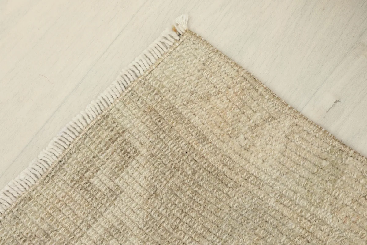 Corner view highlighting the hand-knotted structure and natural fringe