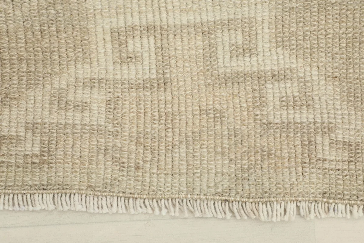 Close-up of the subtle geometric patterns and texture of the low wool pile