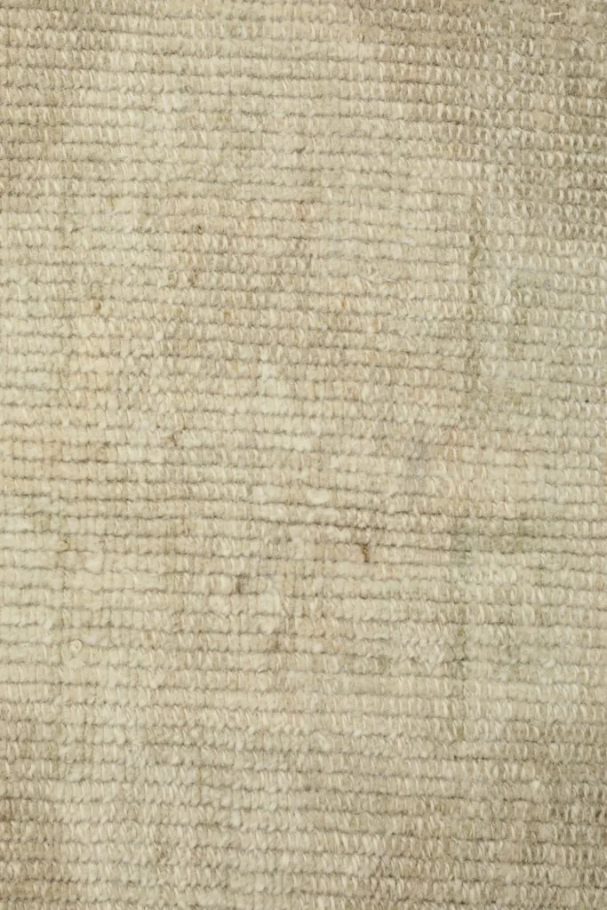 Detailed view of the low wool pile texture and natural variations in color
