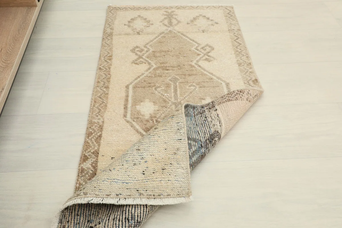 Rug partially folded, displaying both the top surface and the back of the weave