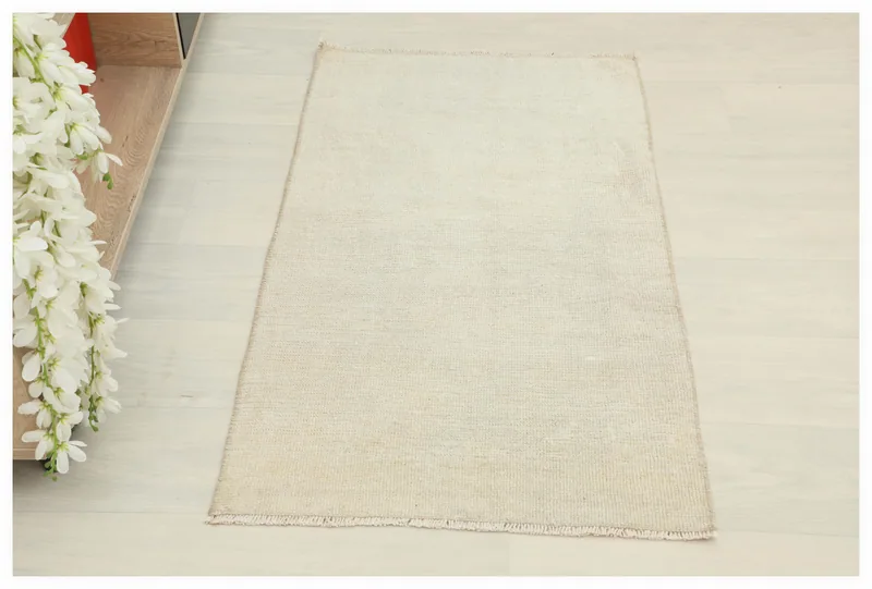 Full overhead view of the cream minimalist vintage Anatolian area rug