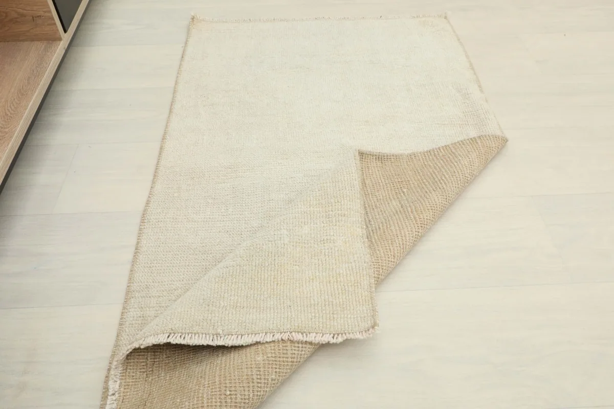 Rug folded back to show both the front and the cotton foundation