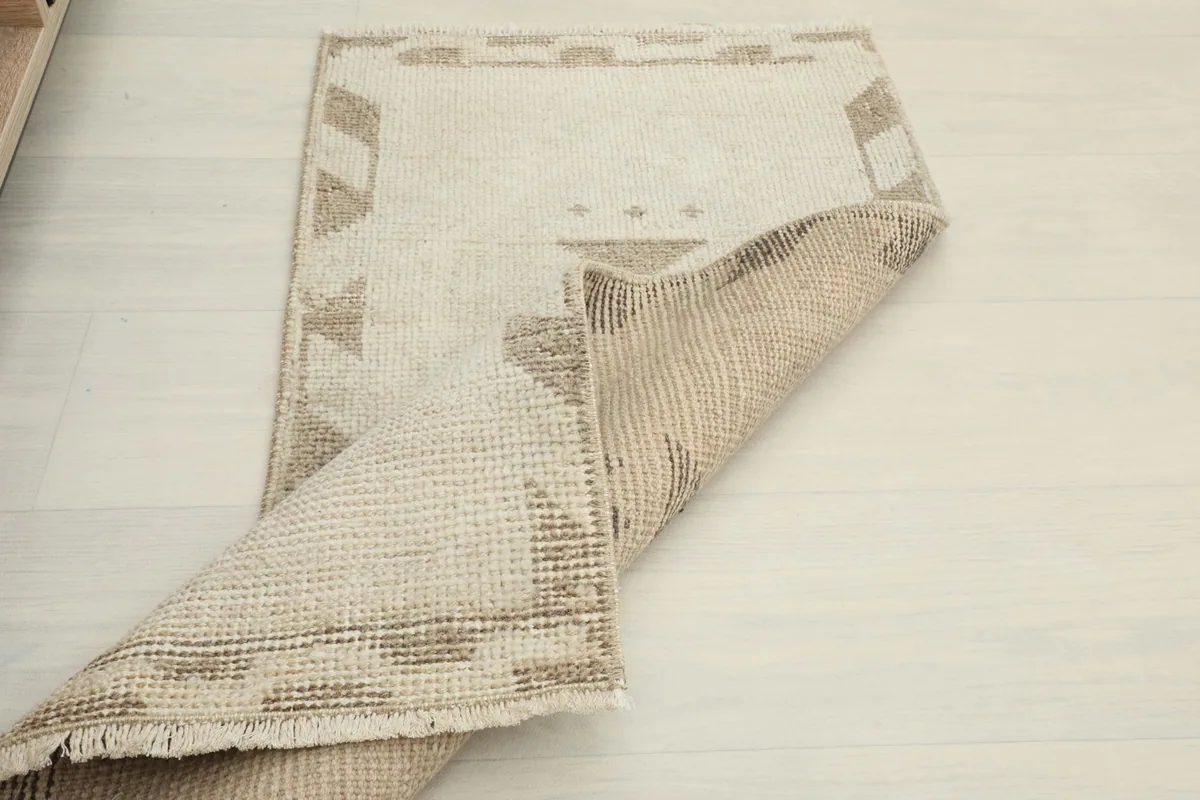 The rug partially folded, showing the flexibility and density of the hand-knotted wool.