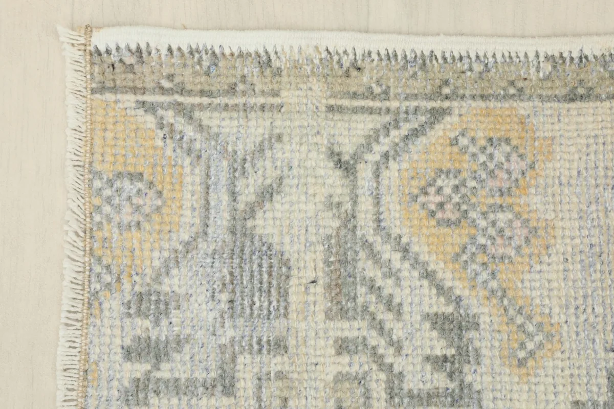 Close-up of the geometric patterns and color variations, including yellow and gray tones.