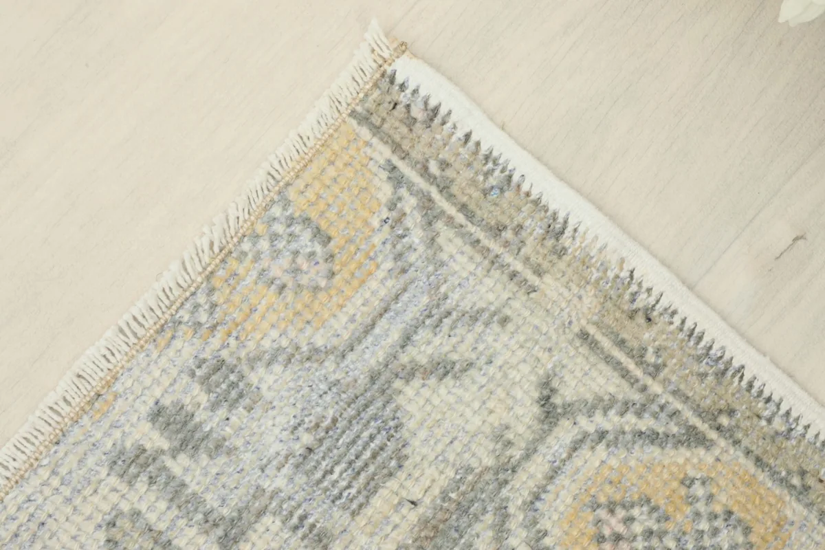 Corner detail showing the hand-knotted edge and the transition from the main field to the border.